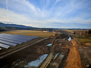 Aerial view of highway under construction alongside a large solar power plant near Ceske...
