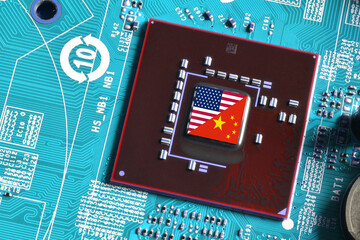 Flag of the Republic of China and the United States on microchip of a printed electronic board. Concept for world supremacy in microchip and semiconductor manufacturing.