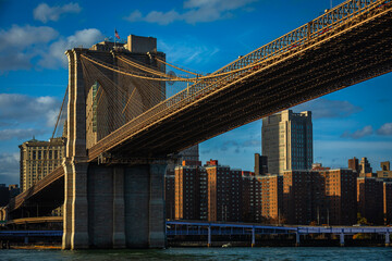 Brooklyn Bridge in Manhattan, New York City, USA in dramatic golden Evening Light; Copy Space