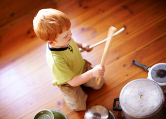 Home, playing and child with pots, drumming and noise with cookware on floor, musician and...