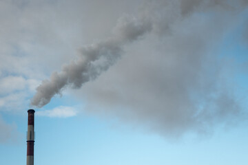 Greenhouse gas emissions into the atmosphere. Smoking power plant chimney, carbon dioxide released into the atmosphere.
