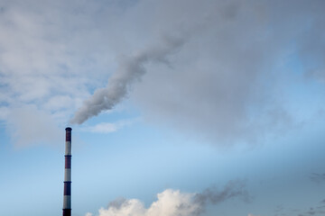 Greenhouse gas emissions into the atmosphere. Smoking power plant chimney, carbon dioxide released...