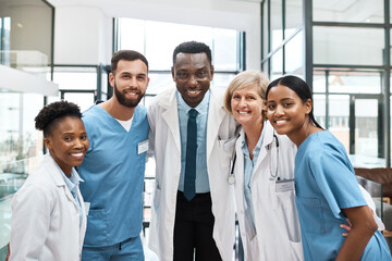 Portrait, group and medical people at hospital with teamwork, healthcare services and wellness support. Diversity, doctors and nurses with embrace for collaboration, health values and treatment trust