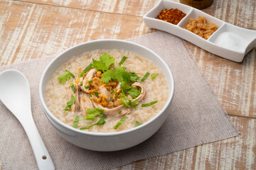 Chicken Porridge,rice soup with Shredded chicken breast in white bowl.Asian breakfast style