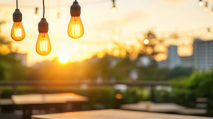 rooftop dining area at sunset featuring hanging light bulbs, creating warm and inviting atmosphere. soft glow of lights enhances serene ambiance of evening
