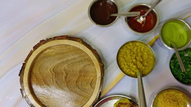 Wooden platter placed with variety of sauces and dips