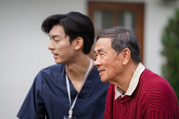 Elderly man enjoying a moment with a supportive healthcare worker, showcasing friendship and care