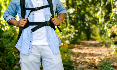 Latino hiker with backpack walking on a jungle trail in Colombia