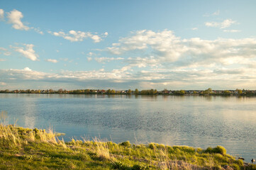 summer landscape, photo of the coast, river, blue sky and clouds