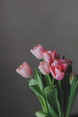 Pink tulips in a glass vase.