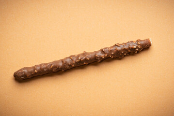Chocolate Coated Snack Stick with Nuts on Brown