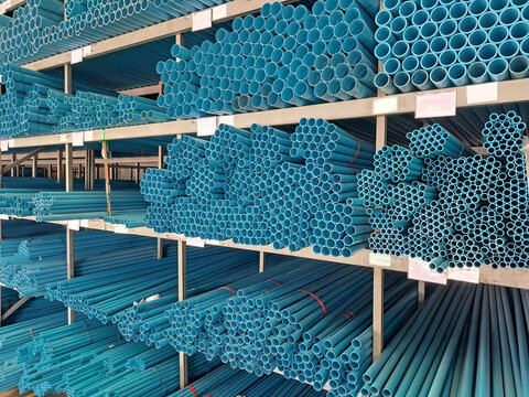 Pvc pipes background.Stacked plastic pipes in a warehouse. Pvc pipes for construction.