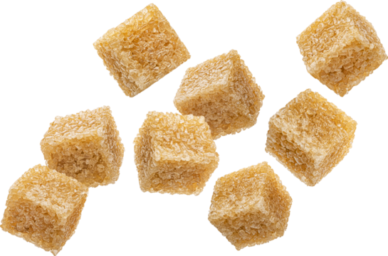 Falling cubes of cane sugar isolated on white background