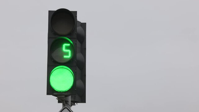 Working traffic light with countdown against the sky, close-up