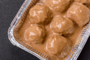 Meatballs with salt and spices in creamy caramel sauce