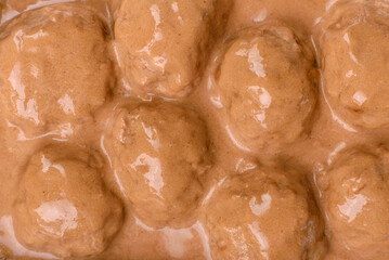 Meatballs with salt and spices in creamy caramel sauce