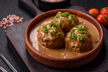 Meatballs with salt and spices in creamy caramel sauce