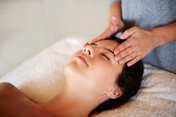 Face, massage and girl on bed at spa for skincare, peace and acupressure with luxury hotel service. Relax, self care and woman on table at beauty salon for holistic facial, wellness or skin treatment