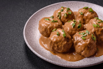 Meatballs with salt and spices in creamy caramel sauce