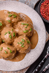 Meatballs with salt and spices in creamy caramel sauce