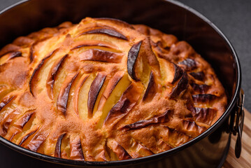 Baked sweet apple pie in a baking dish