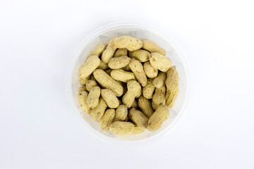 Peanut in bowl isolated on white background, top view.