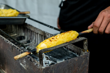latin man preparing traditional bolivian food called sonso - gastronomy concept