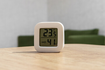 Small digital indoor temperature and humidity meter. Temperature sensor in living room. Temperature control
