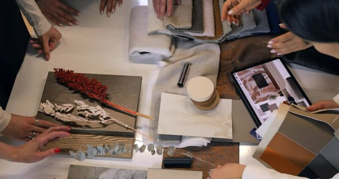 Interior designer reviewing material swatches and color palette on tablet, working on comprehensive design plan with wood, fabric, and tile samples. Concept selection of interior design. Brain Storm