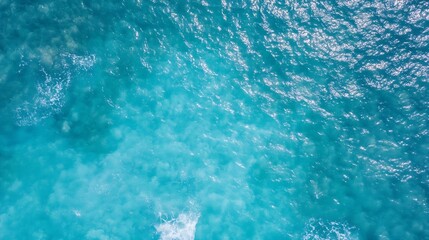 Obraz premium Aerial view of vibrant turquoise ocean waves with sunlight reflecting on the water surface : Generative AI