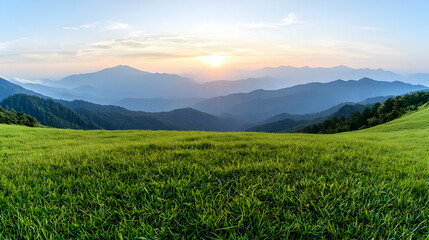 Fototapeta premium Sunset over mountain range, grassy meadow foreground, peaceful landscape, travel photography