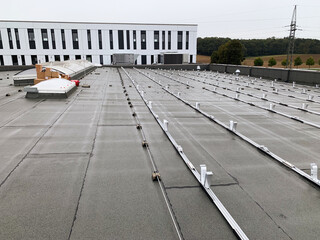 Aluminum Mounting Structures on a Flat Roof Prepared for Solar Panel Installation