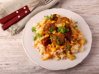 Sweet and sour meatballs with pineapple, corn and pepper