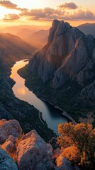 Obraz premium Scenic sunset over a winding river and rocky landscape