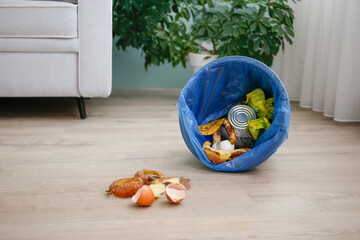 The garbage from the trash can on the floor in the house.