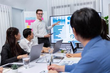 Presentation in office or meeting room with analyst team utilizing BI Fintech to analyze financial...