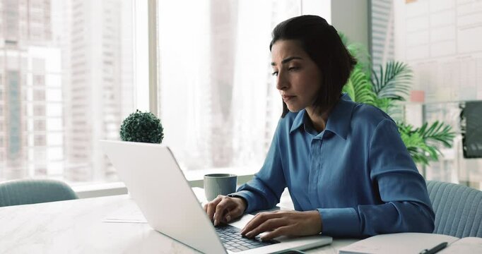 Latina businesswoman reading negative news with concerned expression, missed professional opportunity, financial losses, looks overloaded, feels tired or stressed due to work-related issues. Deadline