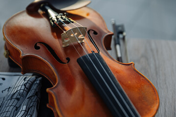 Close-up of a wooden violin on a gray background