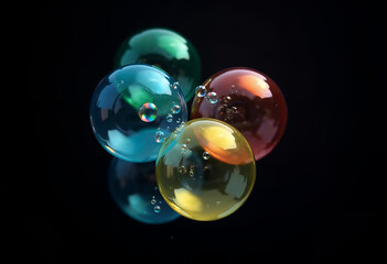 Four translucent bubbles with varying colors, including shades of blue, green, yellow, and red, are clustered together against a black background. Each bubble reflects light 