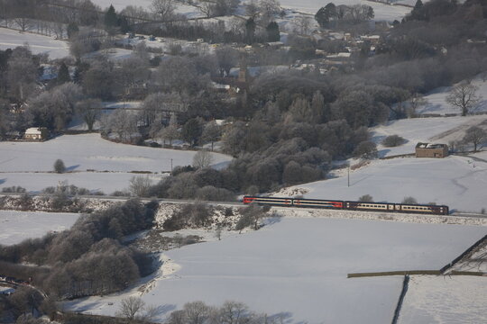train to edale arriving in the peak district during winter with snow surrounding the hills