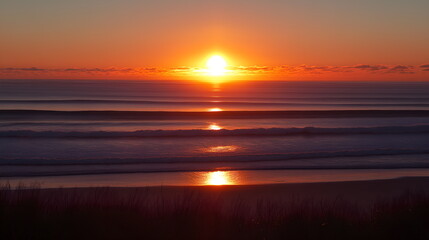 Obraz premium Majestic sunrise over the ocean, golden sun emerging from the horizon, vibrant sky with shades of orange, pink, and purple