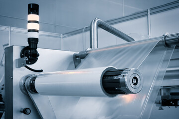 Industrial machine for production and printing of polyethylene bags. Industrial concept background