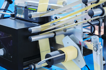 Fragment of the conveyor of sticking labeling machine. Abstract industrial background.
