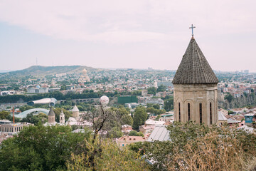 Fototapeta premium Panoramic view of an old city with historic architecture and modern buildings. Tbilisi, Georgia
