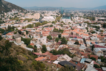 Obraz premium Panoramic view of an old city with historic architecture and modern buildings. Tbilisi, Georgia