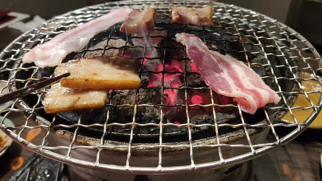 griling bacons and pork slices on on metal mesh for grill