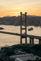 Sunset over big Tsing Ma transportation bridge. Hong Kong.