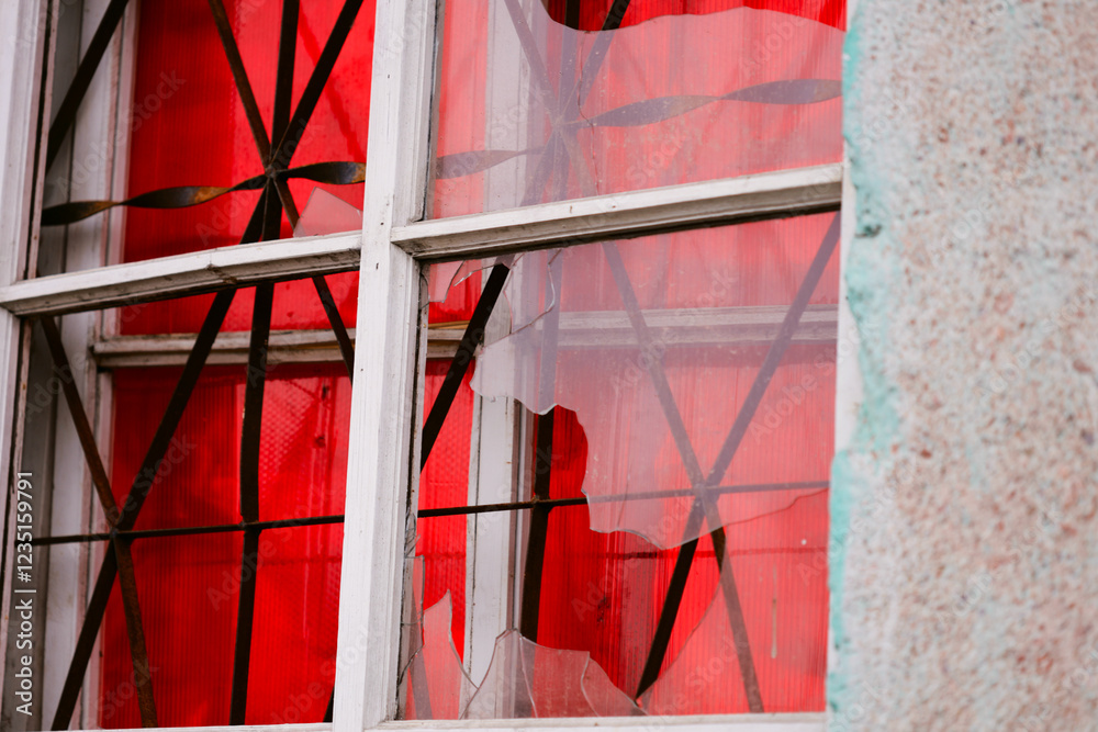 Poster A window with a broken glass pane and a red curtain hanging in front of it.