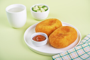 Asian potato cakes with filling, croquet, korokke with tomato sauce in a plate