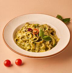 fresh Pesto Pasta with plenty of pesto sauce on a plate for restaurant menu and food ecommerce close up